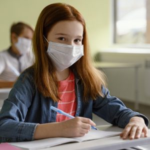 children-with-medical-masks-studying-school